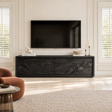 Living room TV console in solid wood with decorative carved panels and low silhouette
