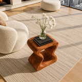 Curved side table adds sculptural character and practical surface to elegant interiors