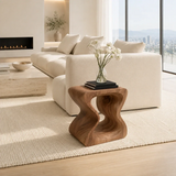 Statement end table with organic openings and bold form in a calm modern home setting