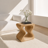 Luxury side table with sculpted frame and compact top in a bright urban living room