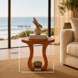 Minimalist side table with curved opening and compact profile for elegant living spaces