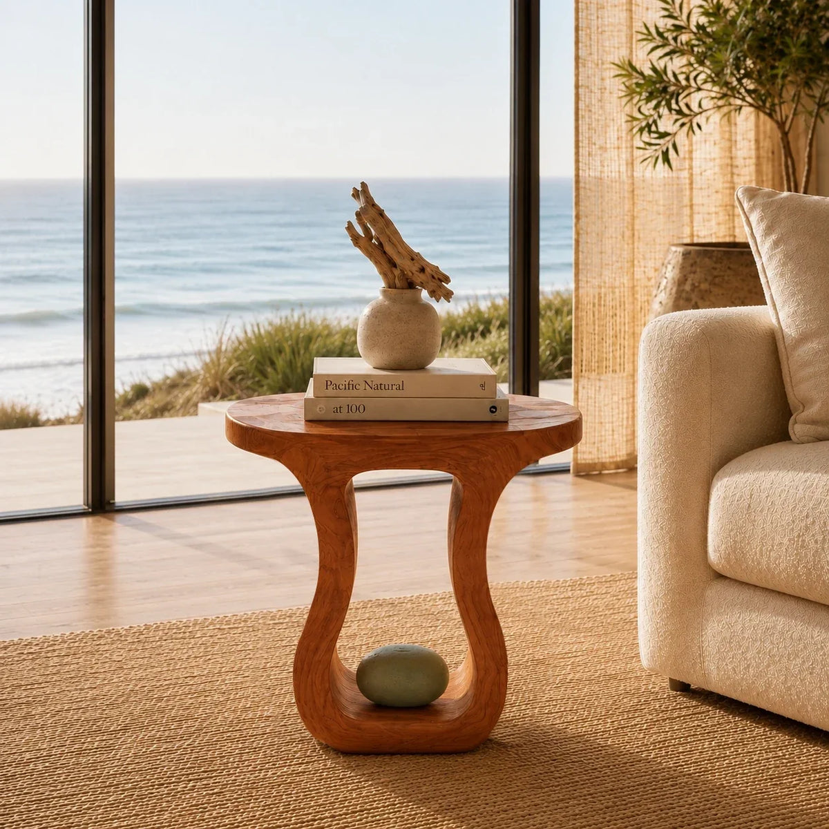 Accent end table featuring a rounded top and sculpted opening for modern home styling