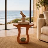 Accent end table featuring a rounded top and sculpted opening for modern home styling