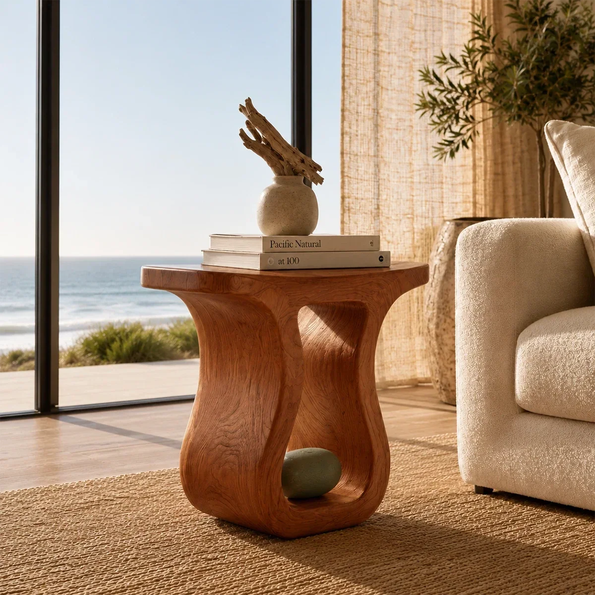 Modern end table with artistic open base and visible grain beside a lounge chair