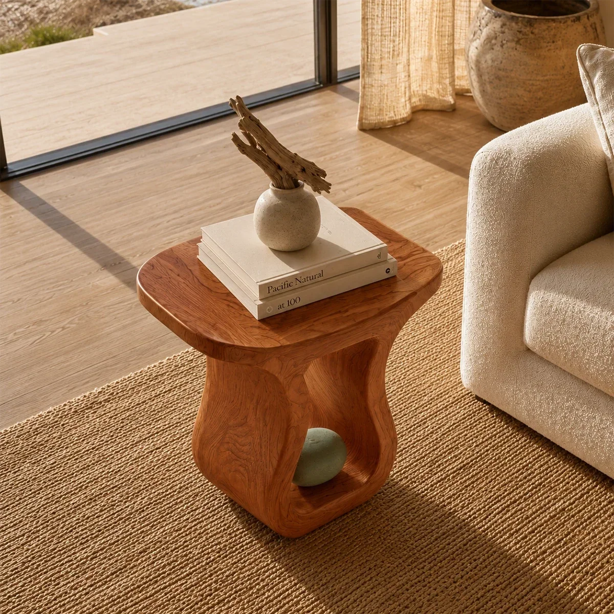 Curved side table adds sculptural character and practical surface to airy interiors