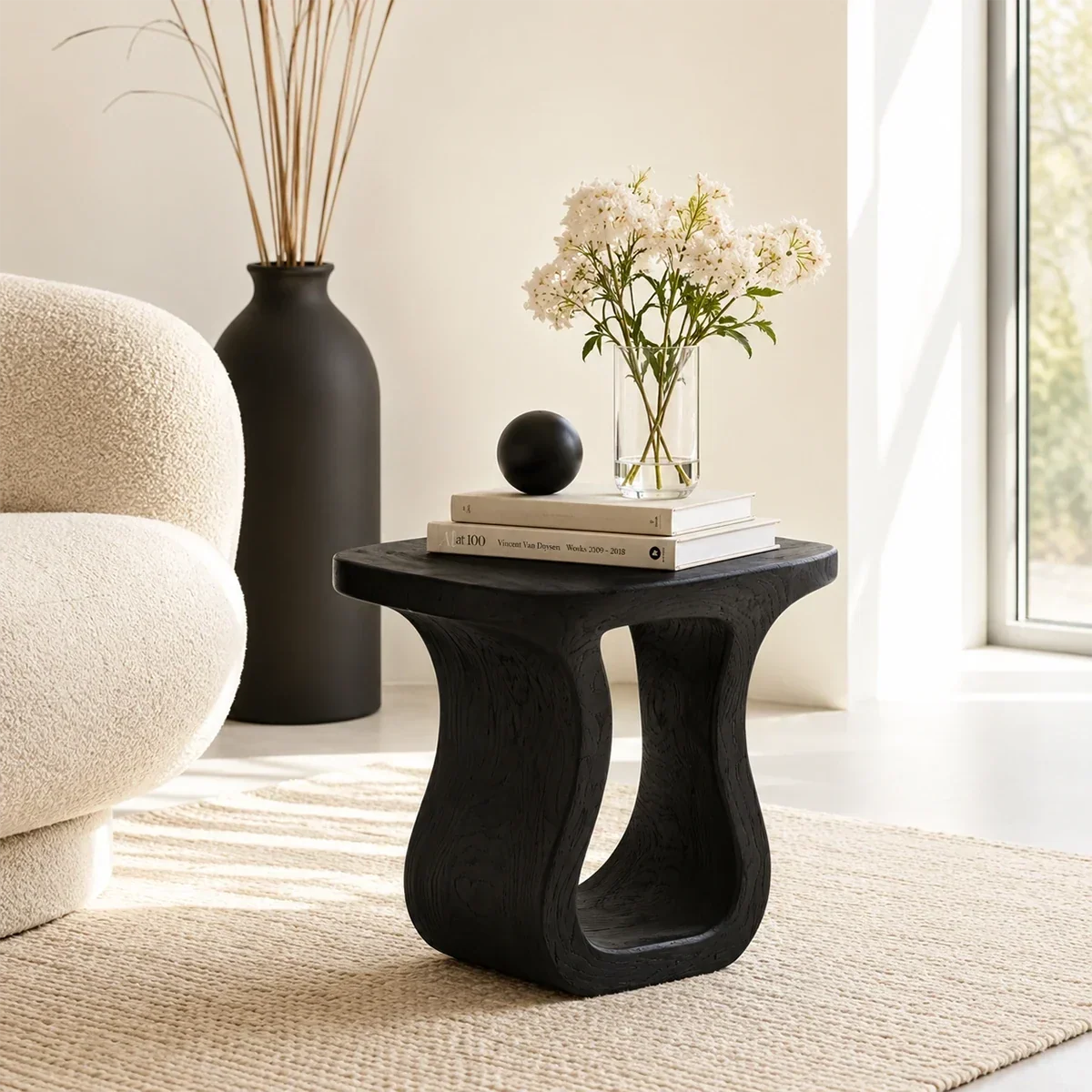 Contemporary end table showcases flowing curves and warm wood tone in an open room
