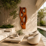 Tall sculptural wall panel with rounded voids brings dimension to a refined lounge setting