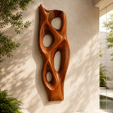 Carved wall decor with open forms introduces movement to a contemporary interior