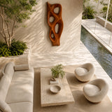 Statement wall sculpture with smooth cutouts adds architectural interest to modern rooms