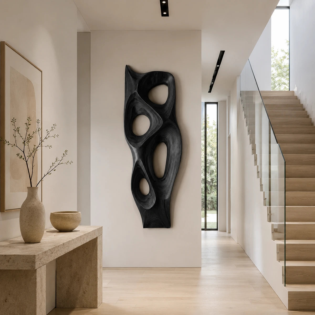 Modern wall sculpture with flowing negative space enhances a bright minimalist interior