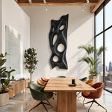 Carved wall panel with flowing negative space creates a refined centerpiece for the home