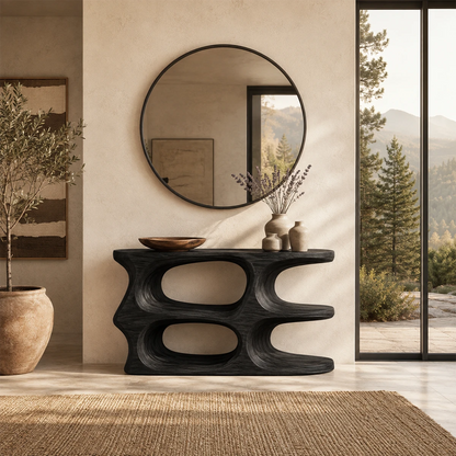 Curved console table displayed beneath wall art in a bright luxury living room setting