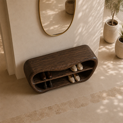 Minimalist entry bench with sculpted form placed beneath an oval mirror in soft sunlight