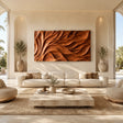 Abstract wall art with flowing carved forms adds depth to a refined modern living room