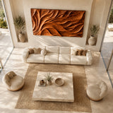 Mounted above seating, this carved wall sculpture brings rhythm to a spacious lounge