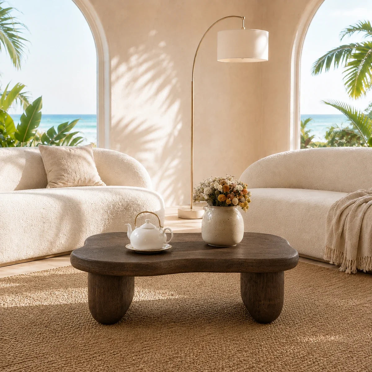 Artisan coffee table with rounded form and dark wood tone finish beside neutral seating