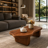 Curved coffee table adds sculptural character and practical surface to airy interiors