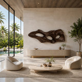 Modern wall art with sculpted openings adds architectural interest to a calm room