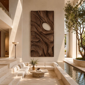 Vertical wall sculpture with flowing carved forms adds depth to a refined modern interior