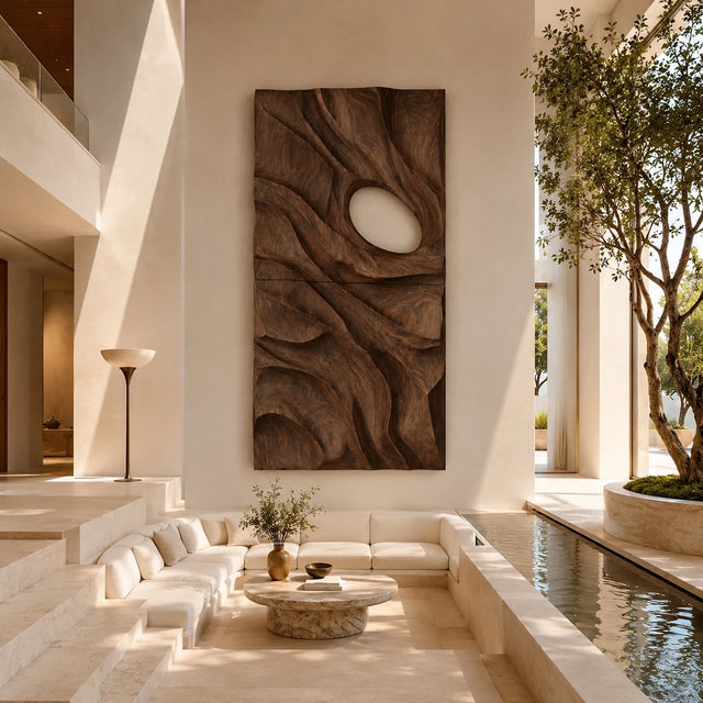 Vertical wall sculpture with flowing carved forms adds depth to a refined modern interior
