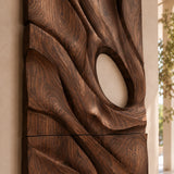 Mounted above seating, this sculptural wall decor adds movement to an airy living space