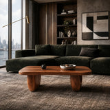 Center table with an oval silhouette and modern sculpted legs in an urban lounge