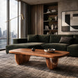 Modern coffee table with oval top and warm wood tone finish in a refined living room