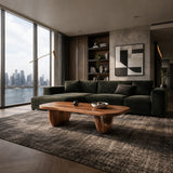 Sculptural coffee table with rounded edges and organic form in a luxury lounge setting