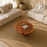 Contemporary solid wood coffee table with floral outline and sculpted base detail