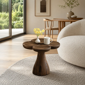 Sculptural end table with petal top and dark wood tone finish in a bright living room