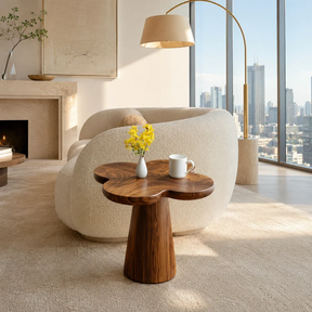 Sculptural end table with clover top and warm wood tone finish in a bright city room
