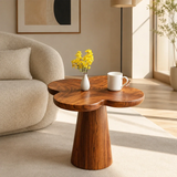 Curved side table adds sculptural character and practical surface to serene interiors