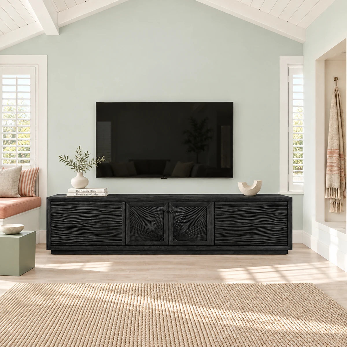 Living room TV console in solid wood with decorative carved doors and wide top surface
