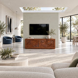 Modern media console in solid wood with sculpted wave panels and broad cabinet storage

