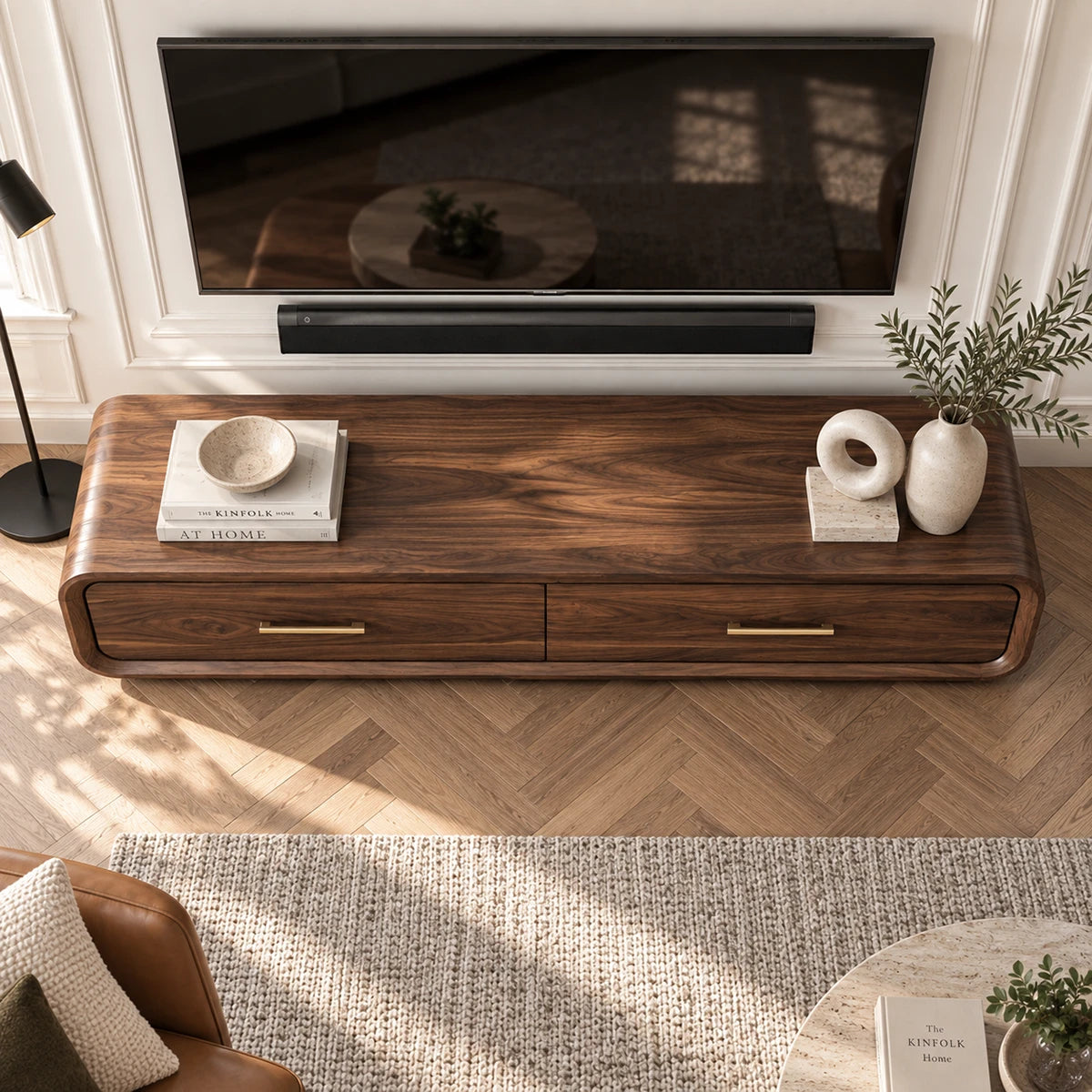 Designer TV stand in solid wood with rounded sides, brass pulls, and hidden storage
