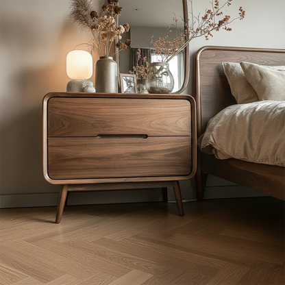 Minimalist bedside storage unit featuring soft corner detailing and smooth walnut tone finish