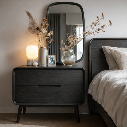 Modern bedroom nightstand designed with softened edges and polished black tone finish