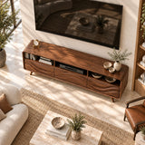 Wide entertainment unit with carved wave panels and accessible storage for media gear