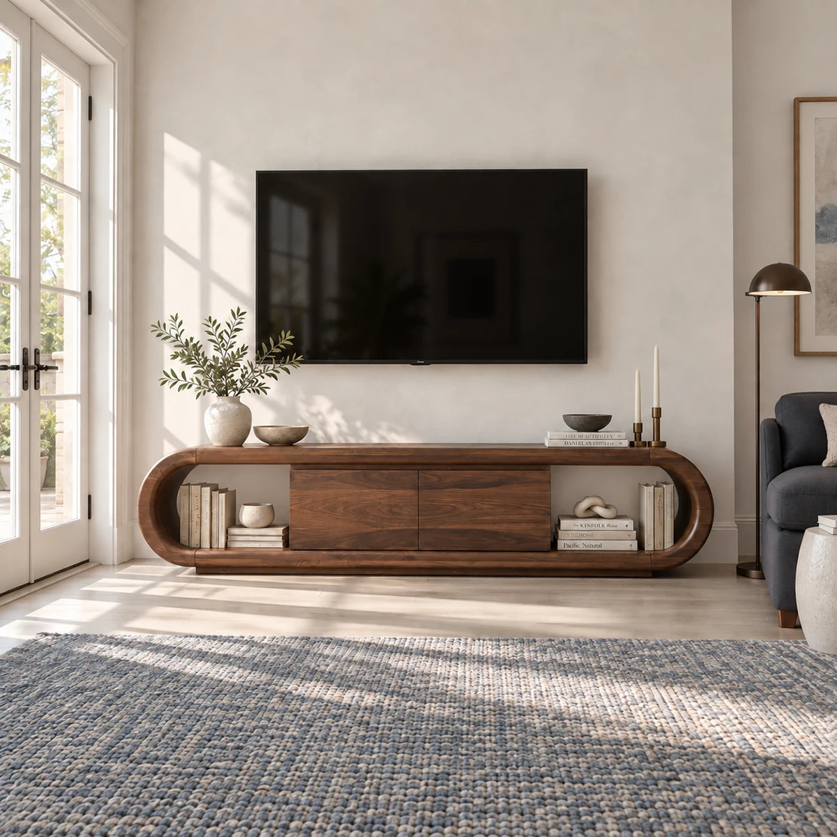 Elegant entertainment console in solid wood with rounded silhouette and shelving
