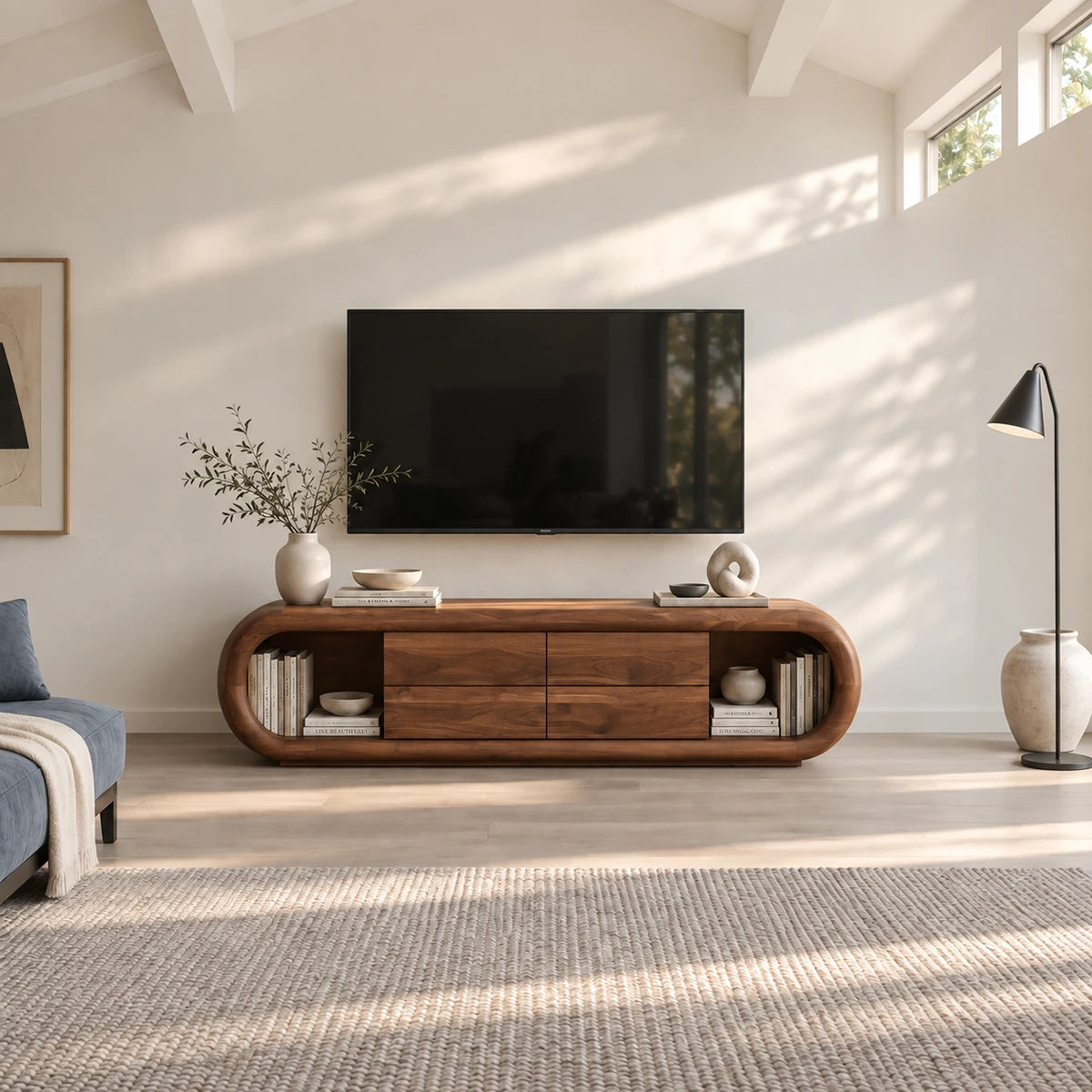Refined media storage unit in solid wood with open shelves and soft curved lines
