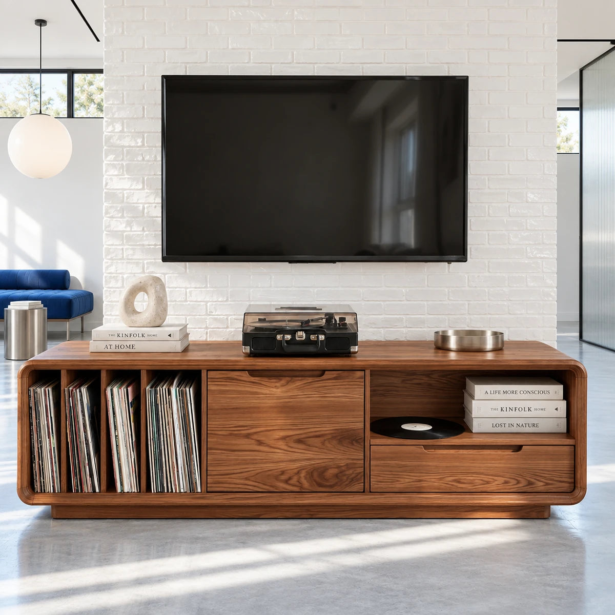 A rounded media cabinet in solid wood with vinyl storage, drawers, and shelf space
