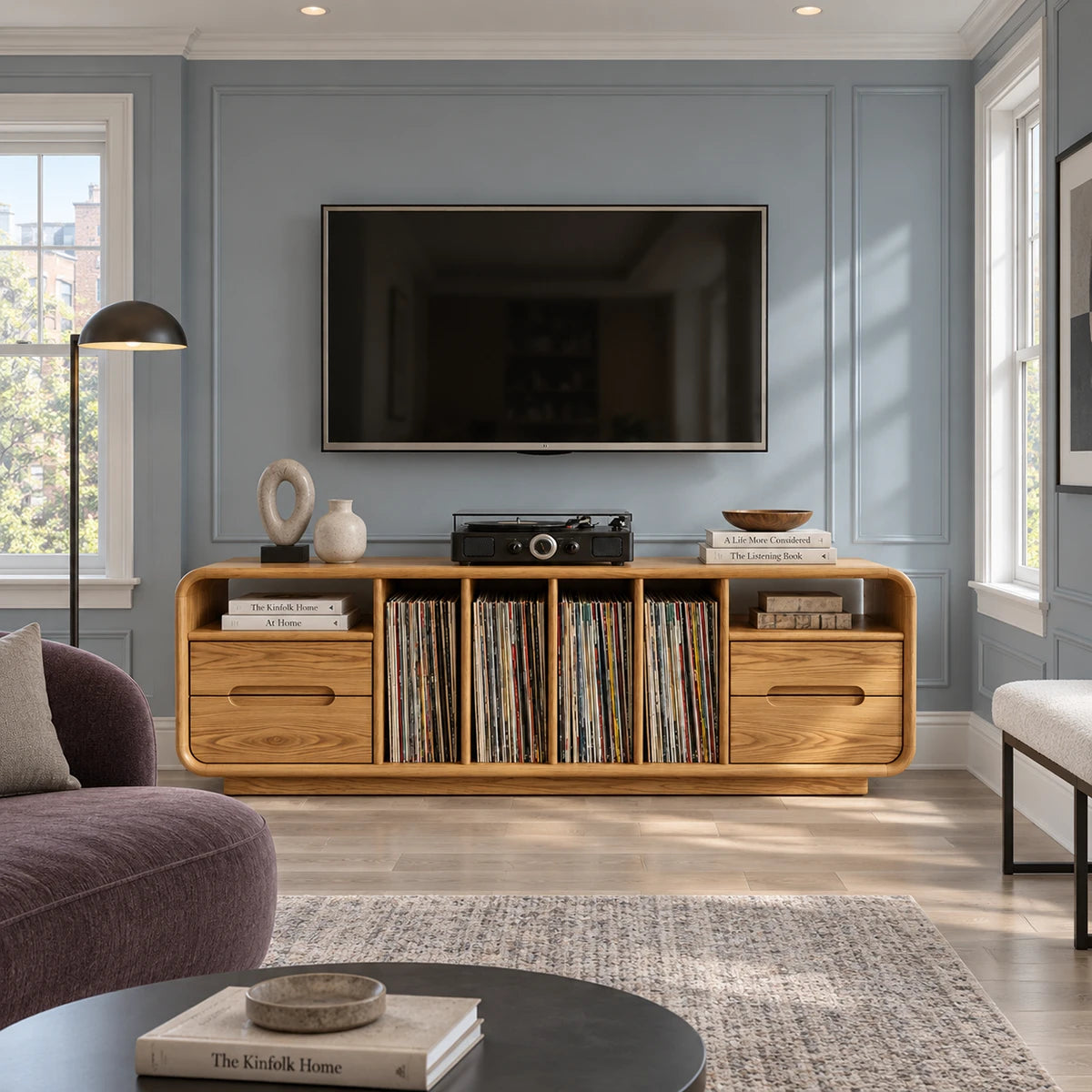 A rounded media cabinet in solid wood with LP dividers, drawers, and shelf space
