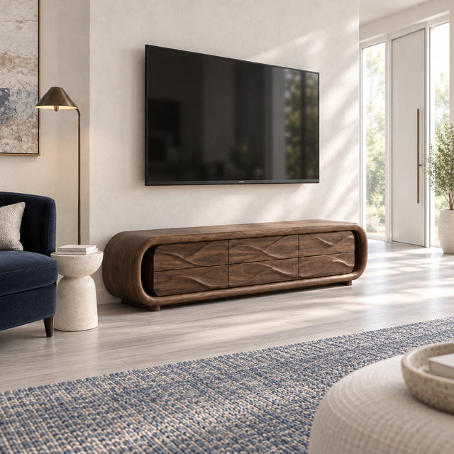 Rounded solid wood TV stand with wave-front drawers in a bright modern living room
