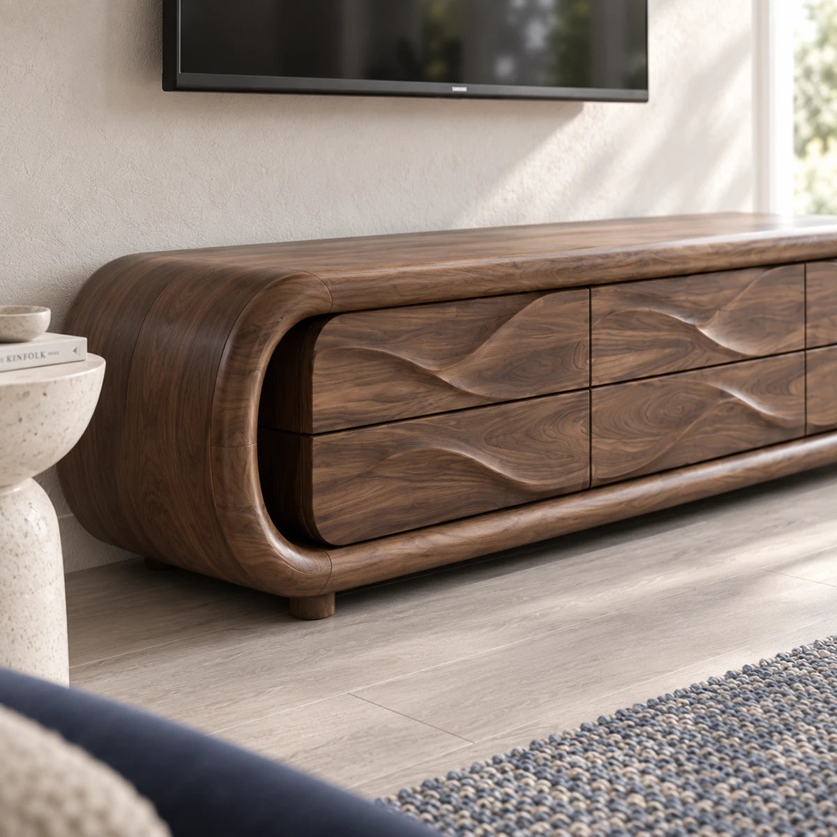 Curved television stand in solid wood with flowing drawer fronts and low silhouette
