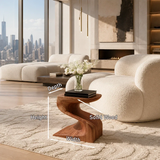 Minimalist side table with flowing support and compact profile for elegant living spaces