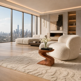 Organic modern side table styled beside curved seating in a refined city interior