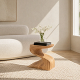 Luxury side table with sculptural pedestal base and compact top in a bright living room