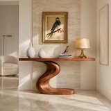 Sculptural console table with an S curve pedestal base in a bright modern hallway