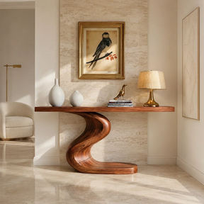 Sculptural console table with an S curve pedestal base in a bright modern hallway