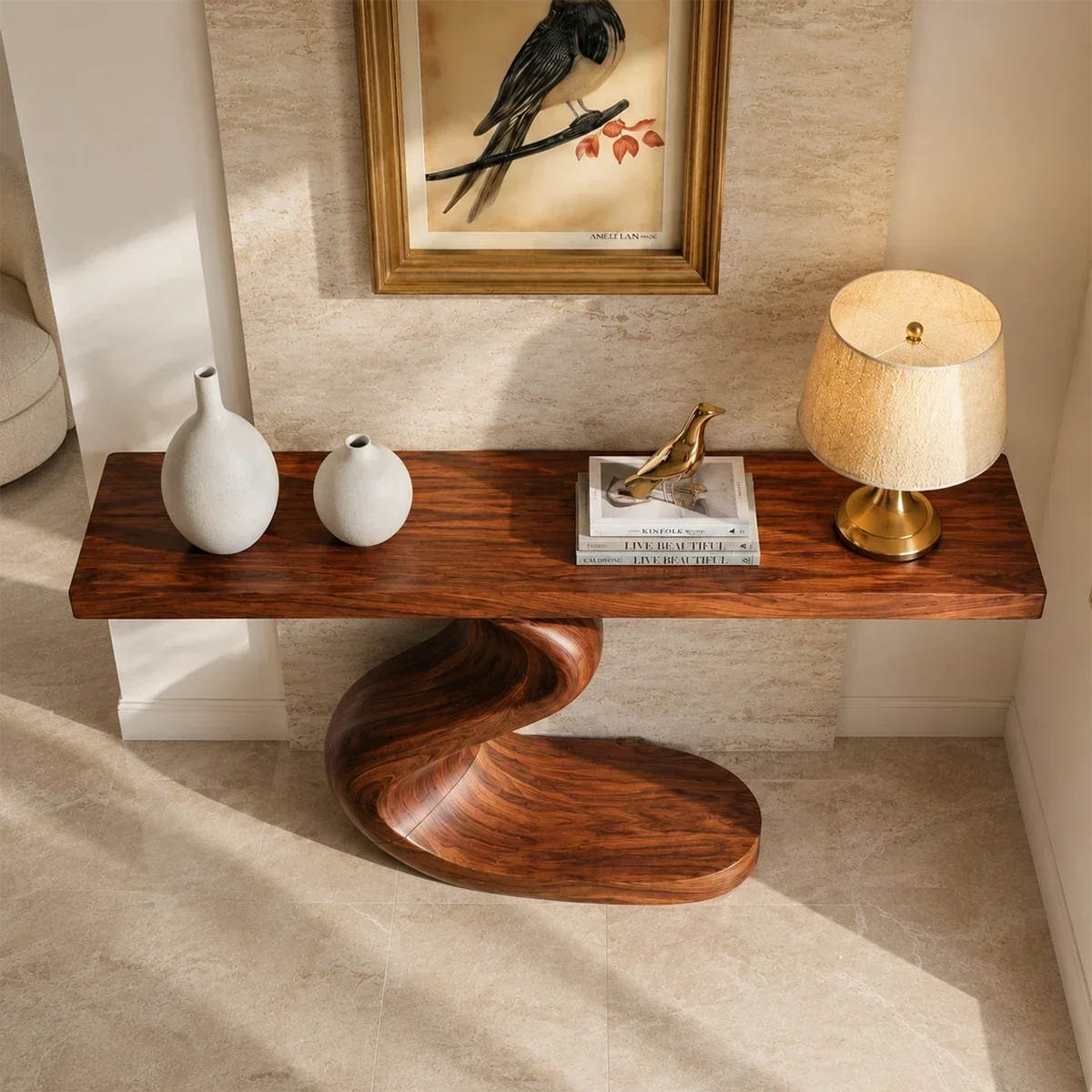 Narrow console table with sculpted S shaped base for elegant foyer decor styling